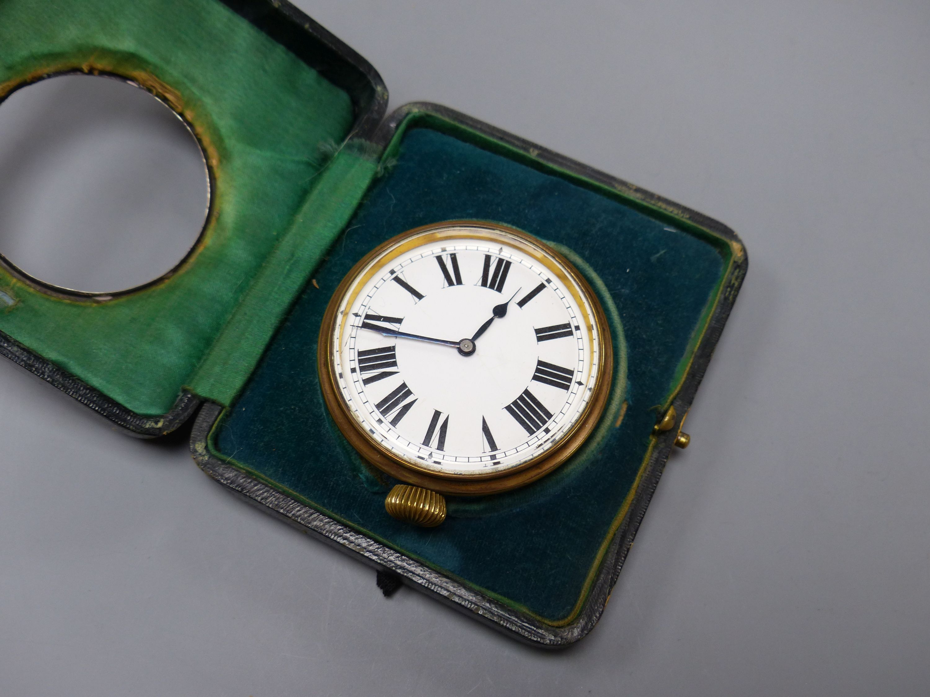 A George V silver mounted travelling watch case, with an incomplete nickel cased pocket watch, 11.2cm.